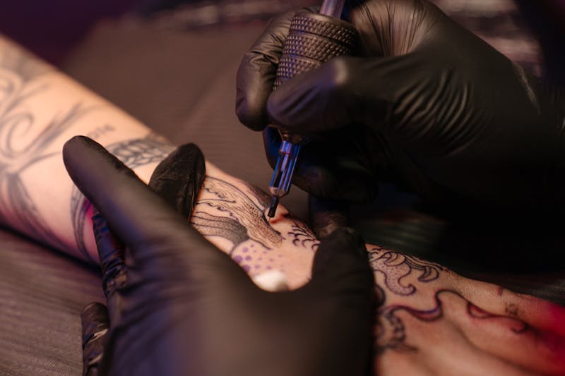 Tattoo artist at work in studio